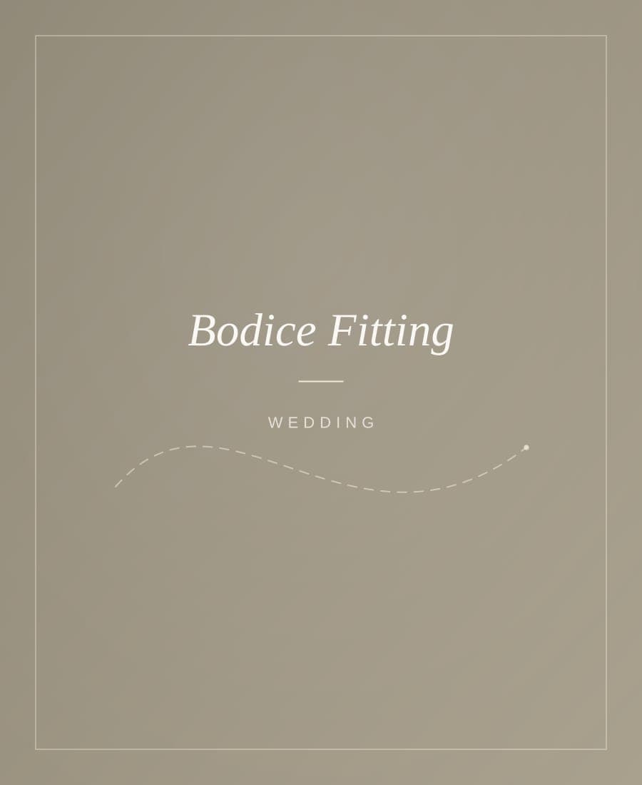 Bridal bodice being shaped and pinned on a dress form