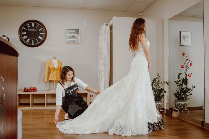 Wedding dress alterations in Tulsa — bridal gown pinned during a fitting